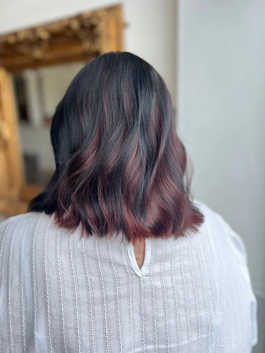The same client after regrowth tint, with a cut and blow-dry finish