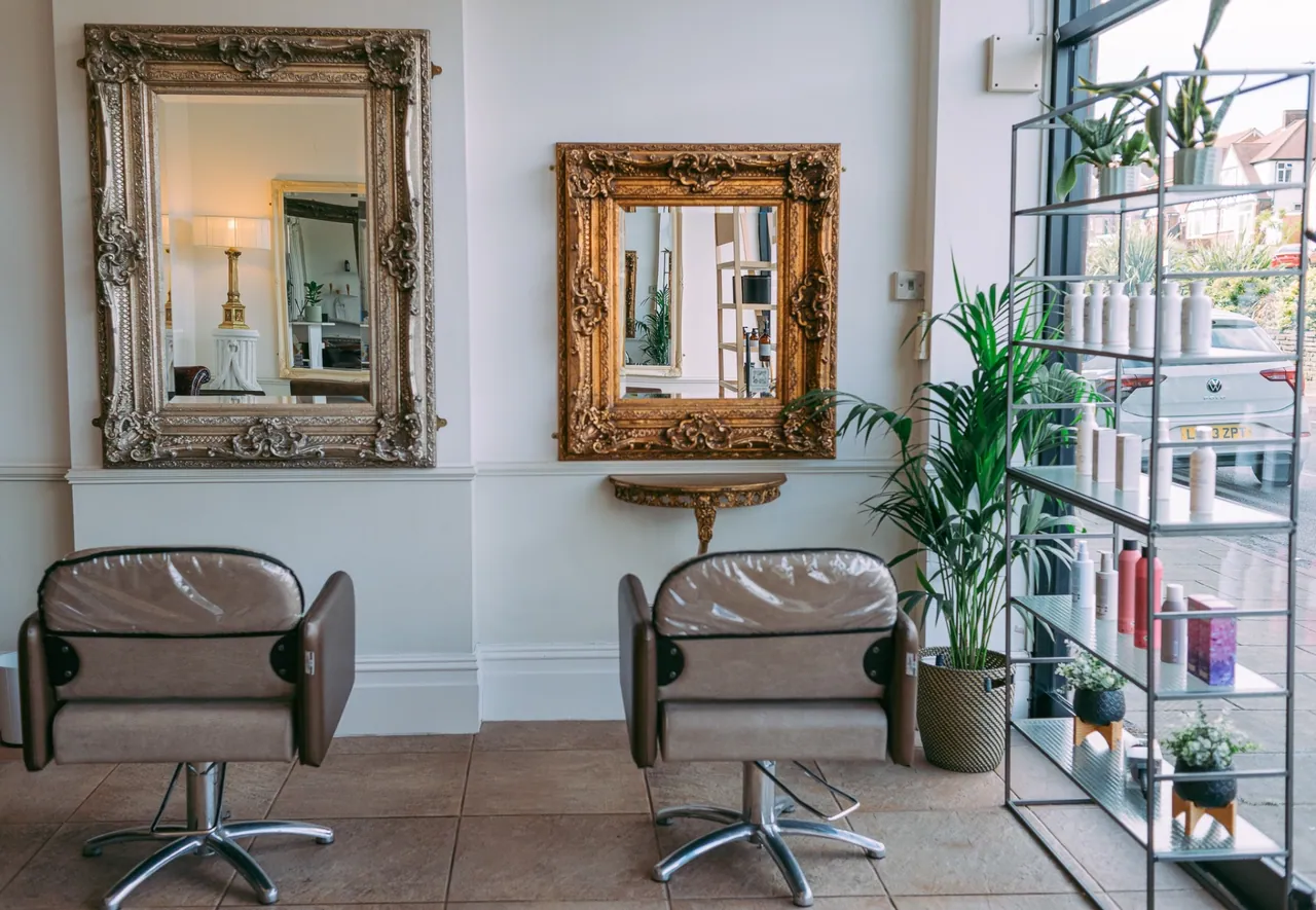 Paired backwash stations beneath gilded mirrors