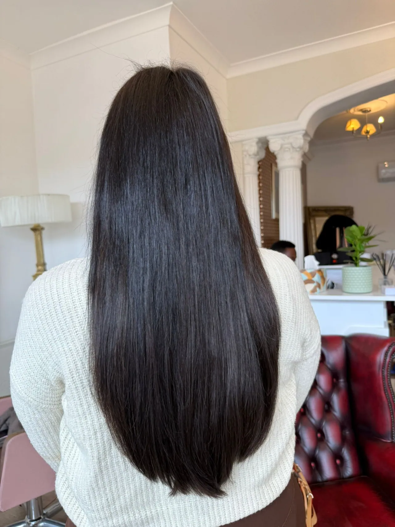 Long, straight dark brown hair extensions finished in salon at Esther Alexander near Epsom