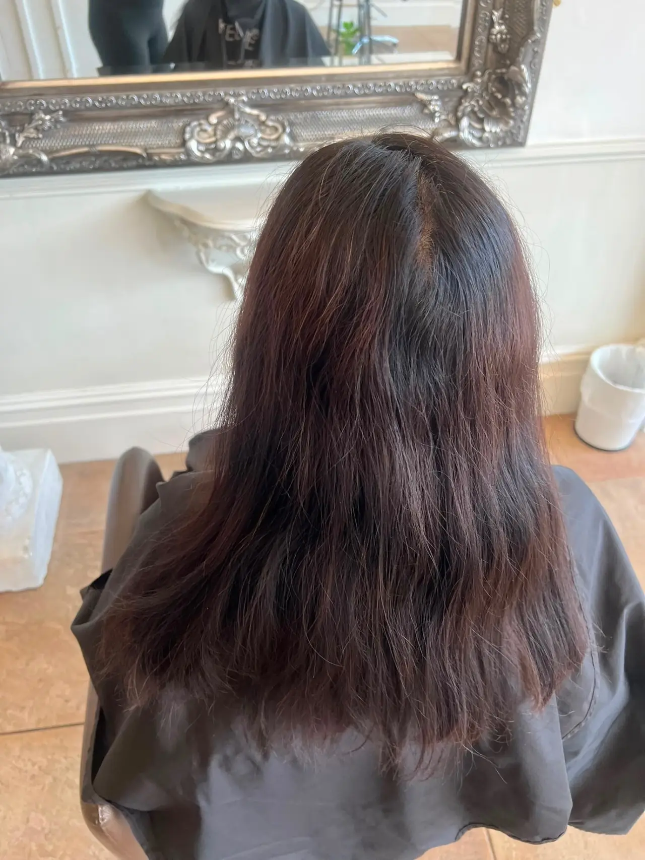 Mid-length dark hair before a keratin smoothing treatment in Ewell