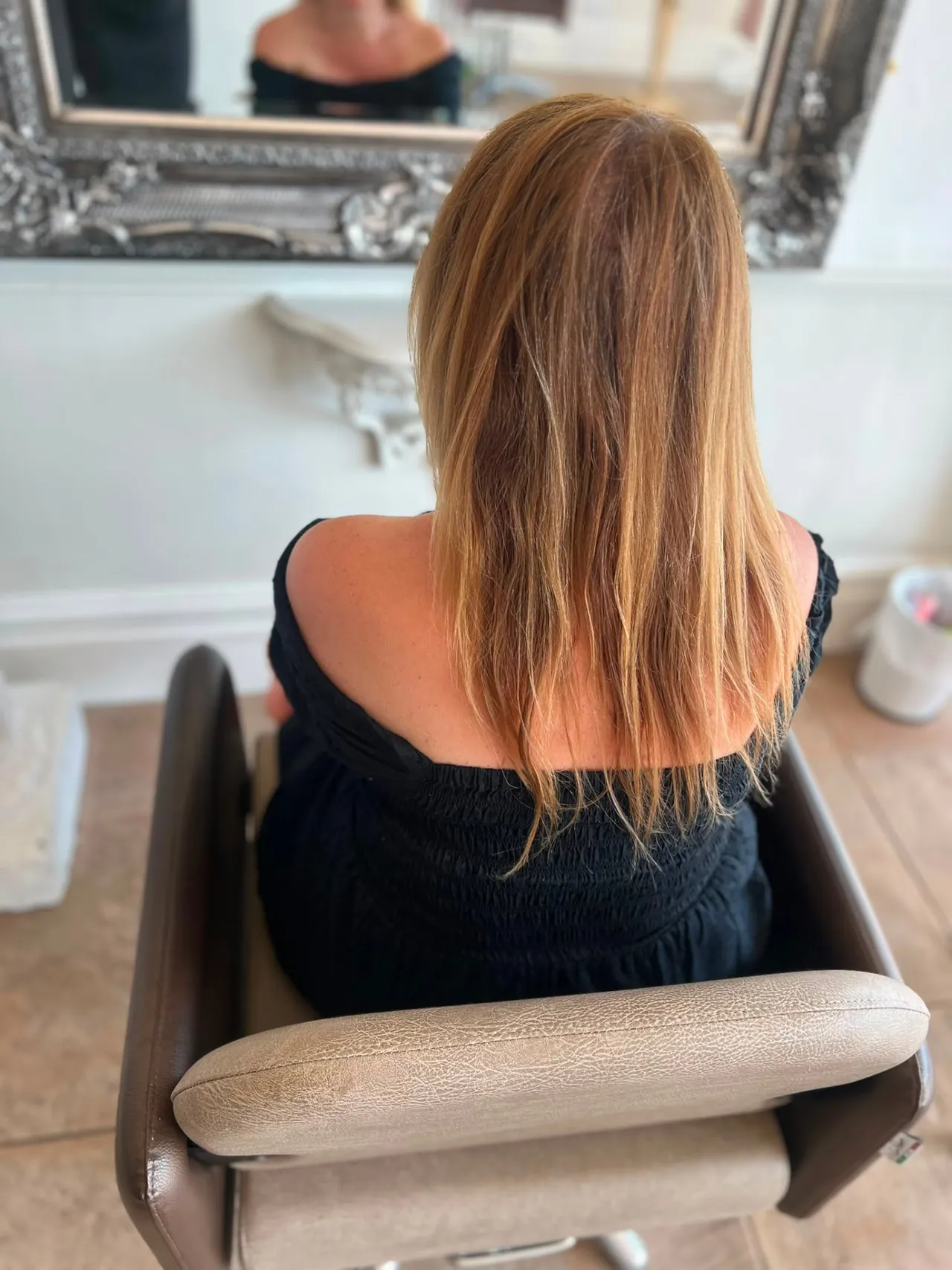 Hair before a tape extension refit, shown from above at the root area