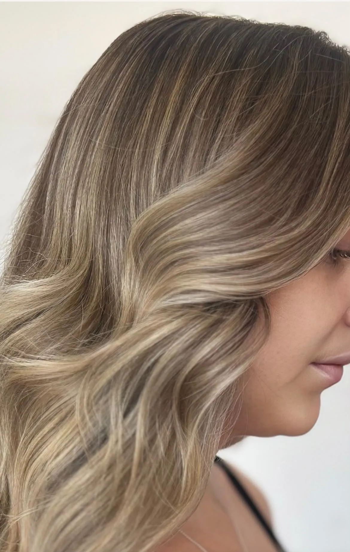 Close-up of blended blonde highlights through mid-brown hair