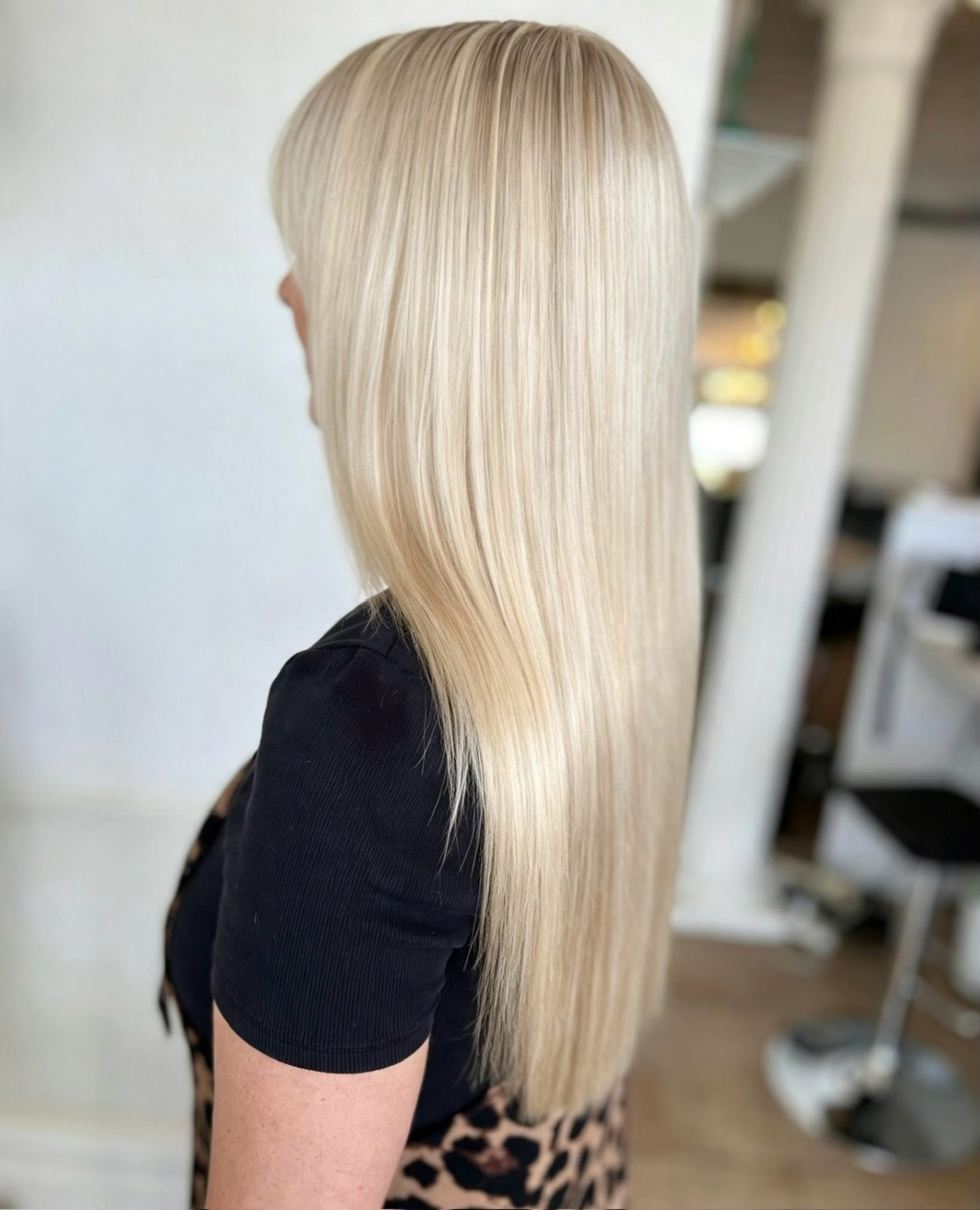 Long creamy blonde balayage sleekly finished at the Ewell salon