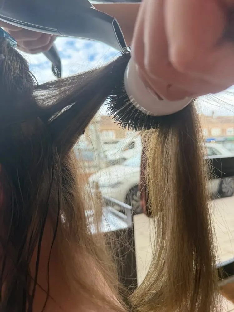 Close-up of a round-brush blow-dry on blended blonde lengths at Esther Alexander