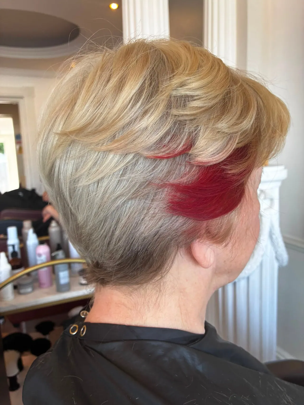 Short blonde crop with a vivid red panel through the nape